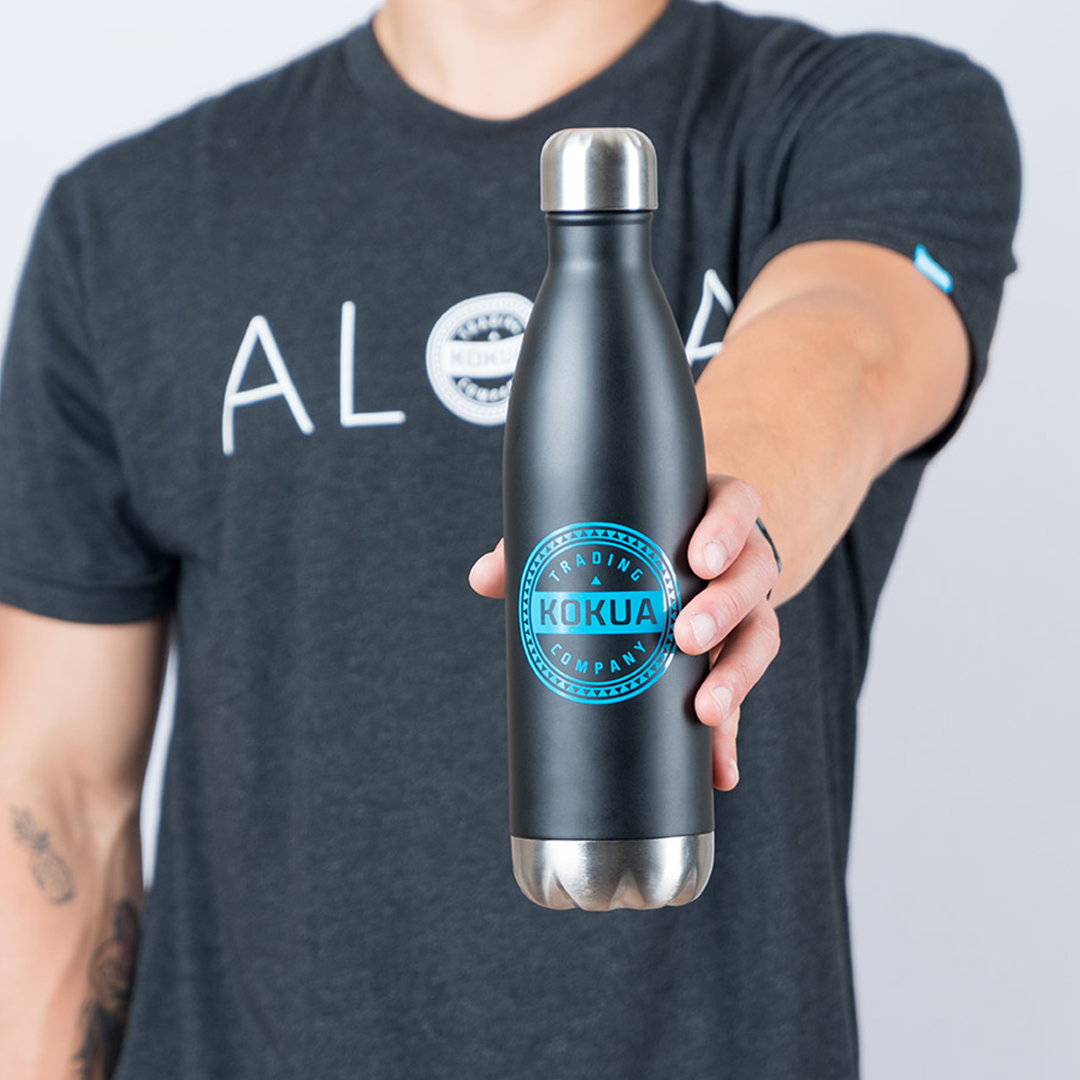 a person holding a black water bottle
