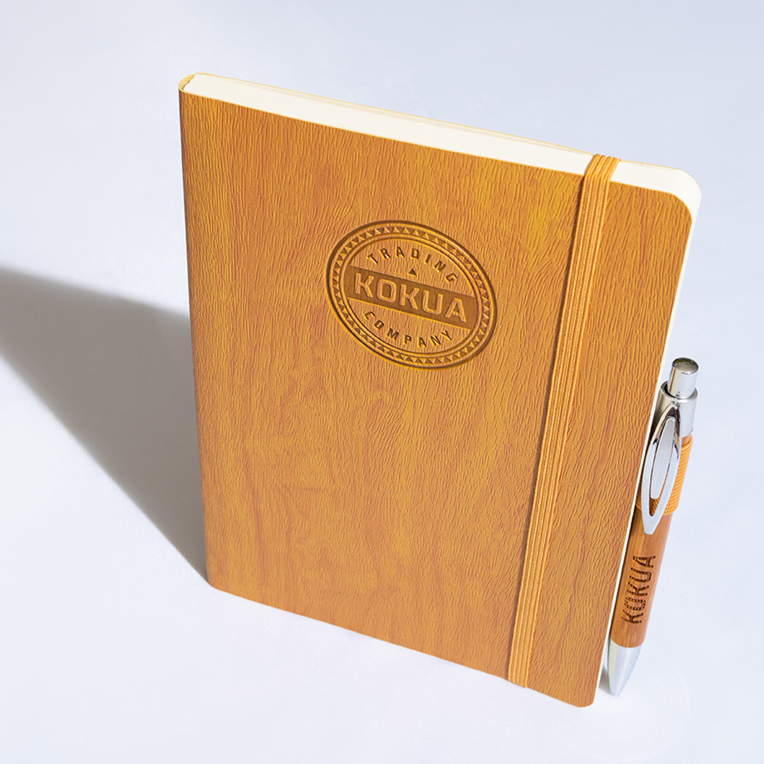 a notebook and pen on a white surface