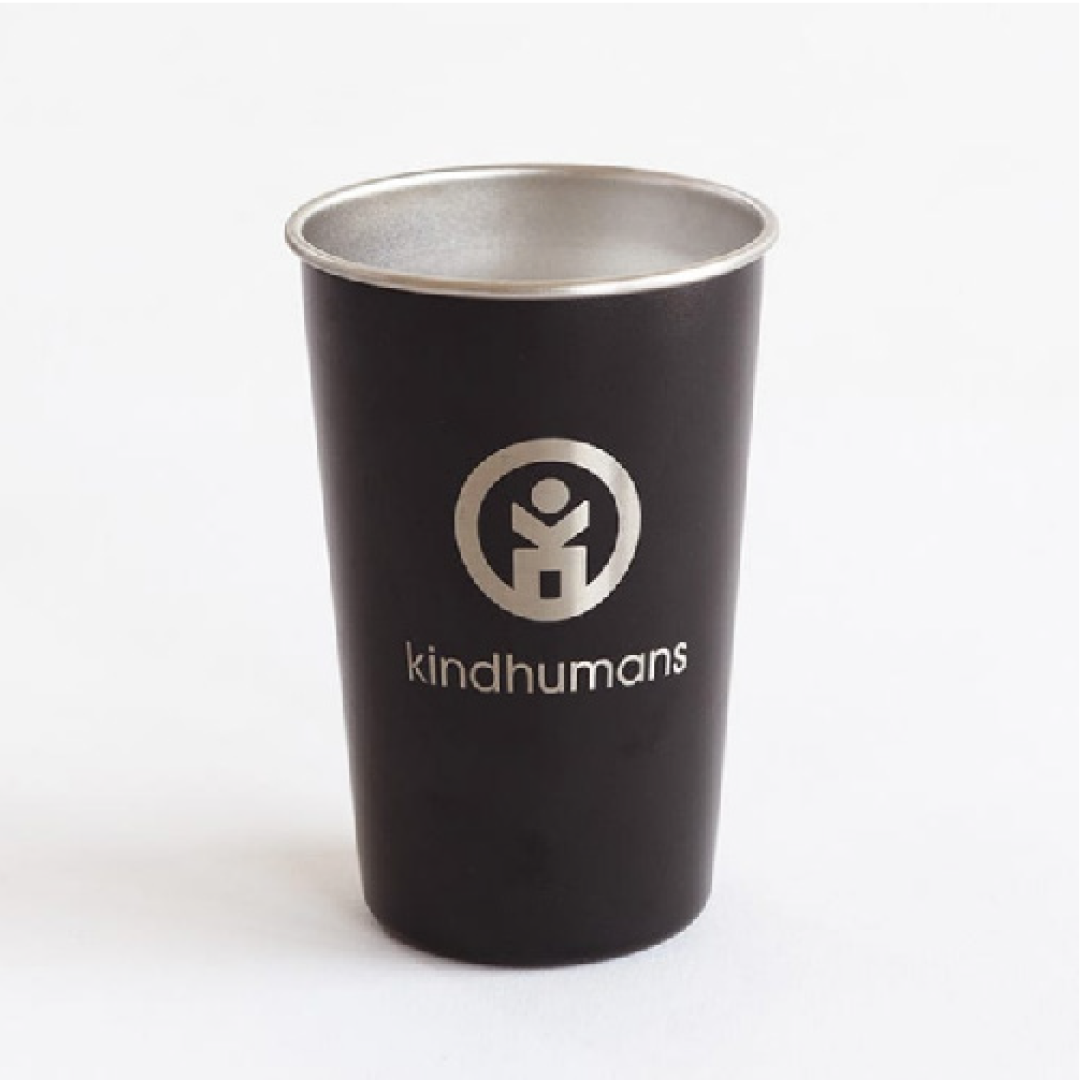 a black cup with silver rim